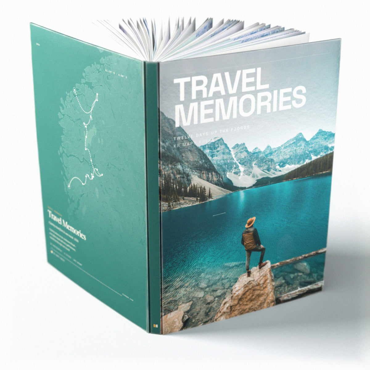 The same A4 portrait hardcover Travel Book, open on the table. The book itself, standing open on a plain background — the printed case bent back so the front cover, the spine and the back cover are all in view at once, and the pages fanned open between them