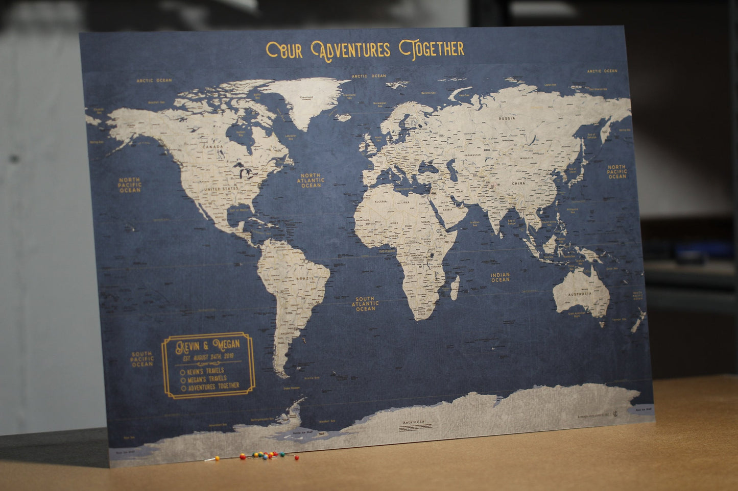 World Map Executive Style Push Pin Travel Map to Mark world travels for wanderlust world travelers in blue and gold colors that pins can stick out of to track your travels