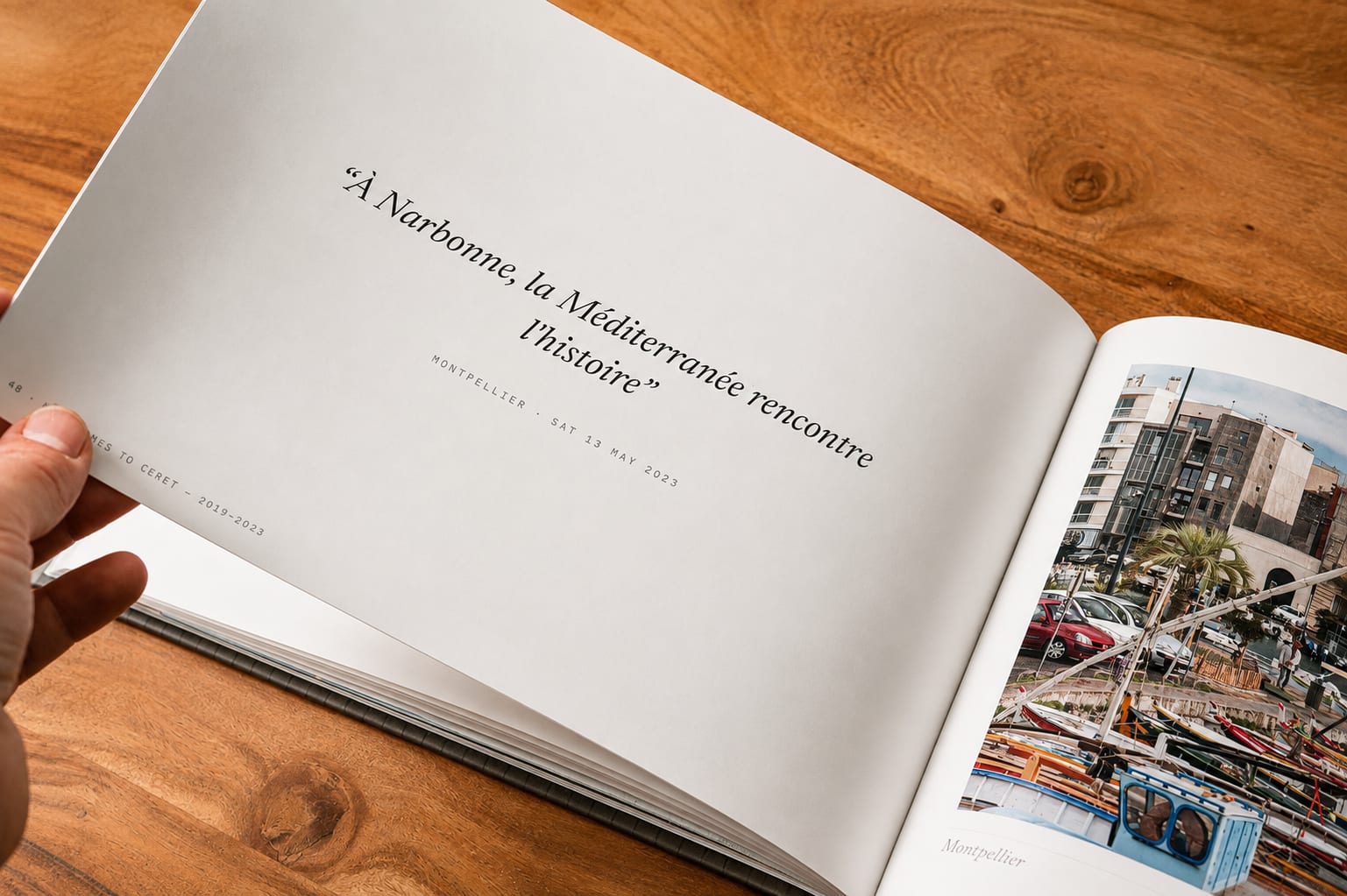 A hand lifting a page mid-turn, a chapter quote page facing a full-bleed photograph