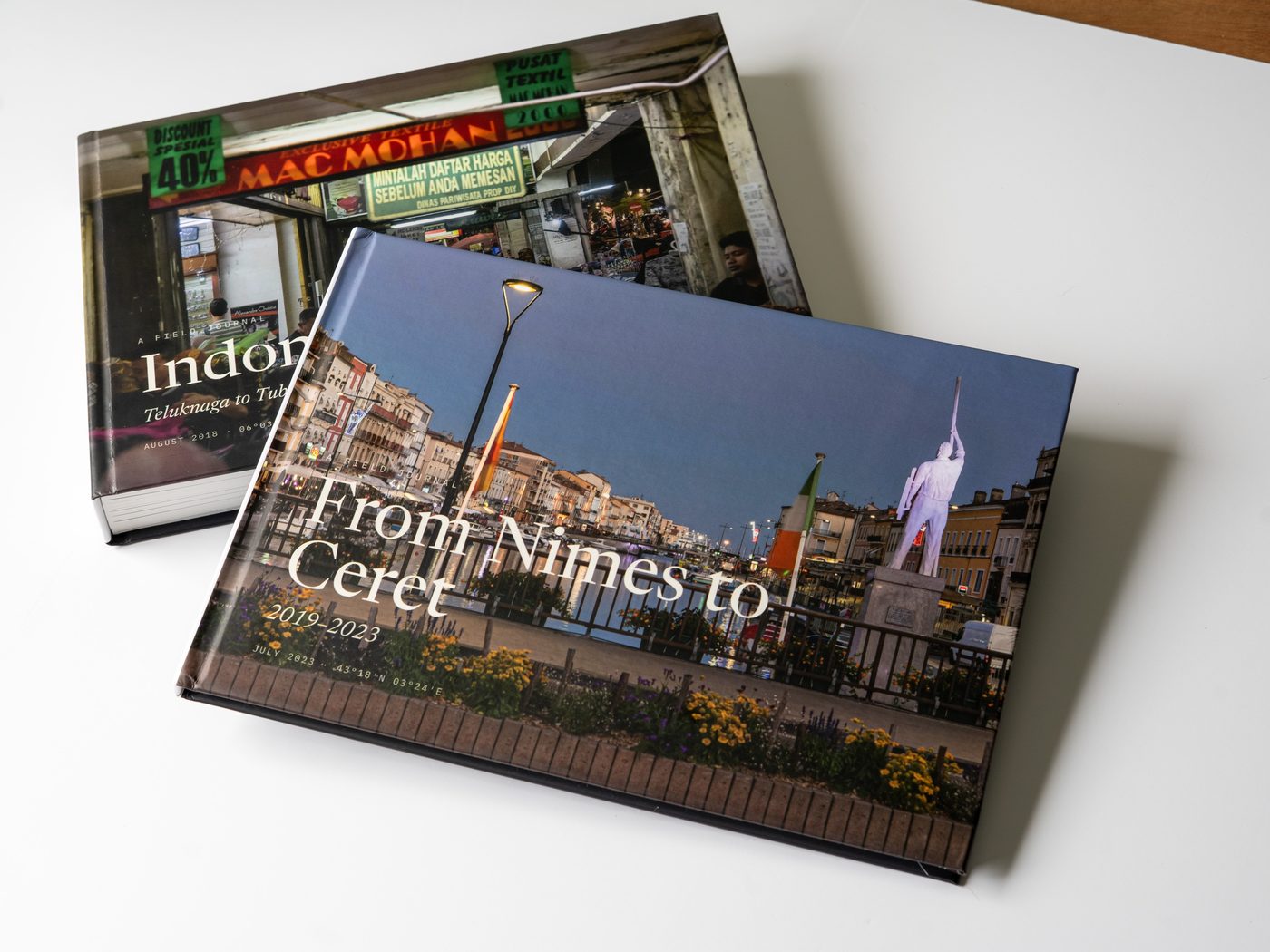 Two finished Travel Books with different covers, resting one across the other