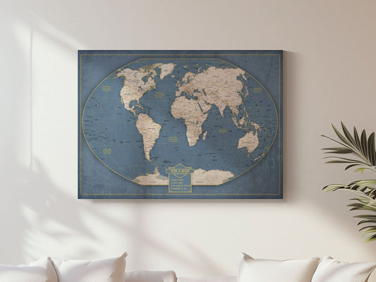 May include: A blue world map with a vintage look. The map is surrounded by a gold border and has a gold title that reads 'The World.' The map is displayed on a white wall with a plant in the background.