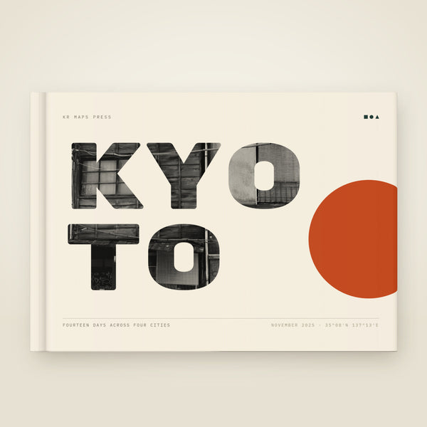 kr-paper:kr-maps-travel-book-a5-hardcover:hero:152194f7 — A A5 landscape hardcover KR Maps Travel Book, closed on a table — a book of a fortnight in Japan, from Tokyo down to Hiroshima, the title set over one of the trip's own photographs