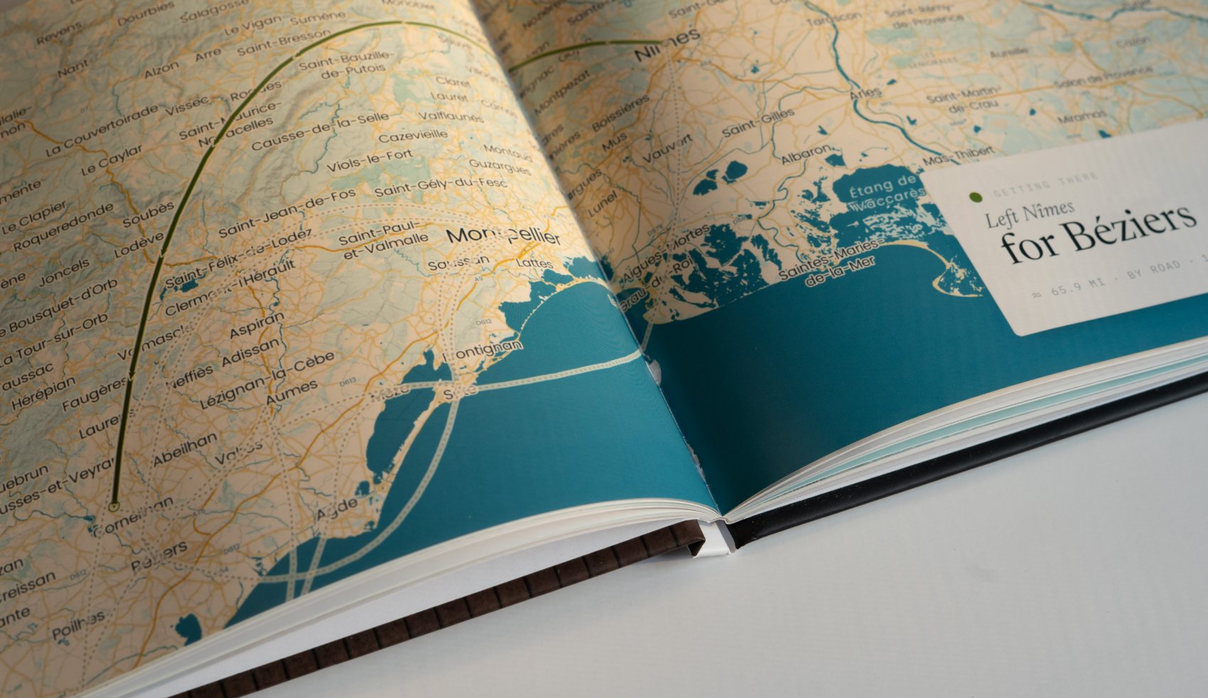 A hardcover Travel Book open on a full-spread map