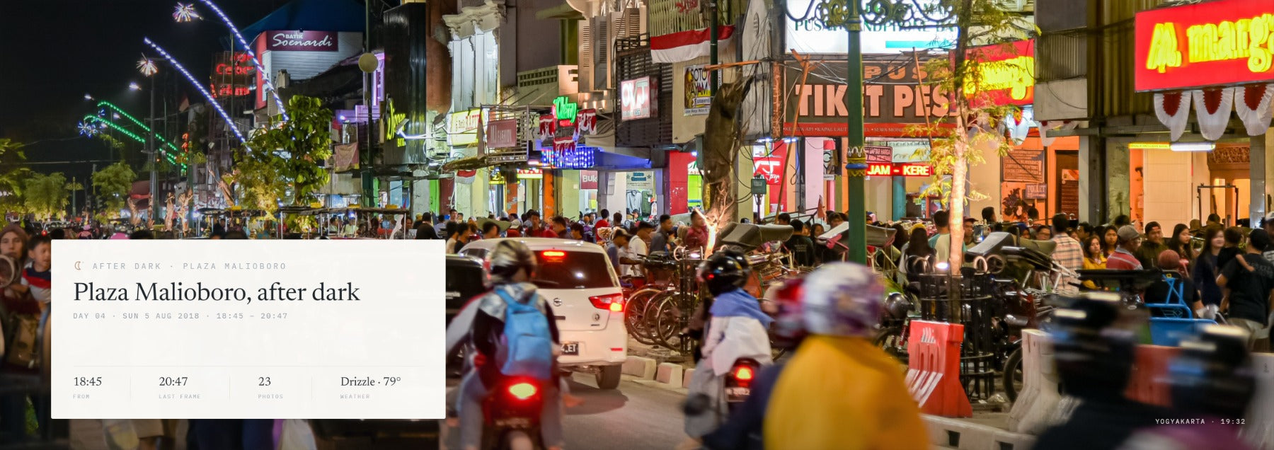 A printed after-dark spread from the Indonesia demo book: Plaza Malioboro at night under neon and shop signs, the photograph running across both pages with the evening&rsquo;s card set into it