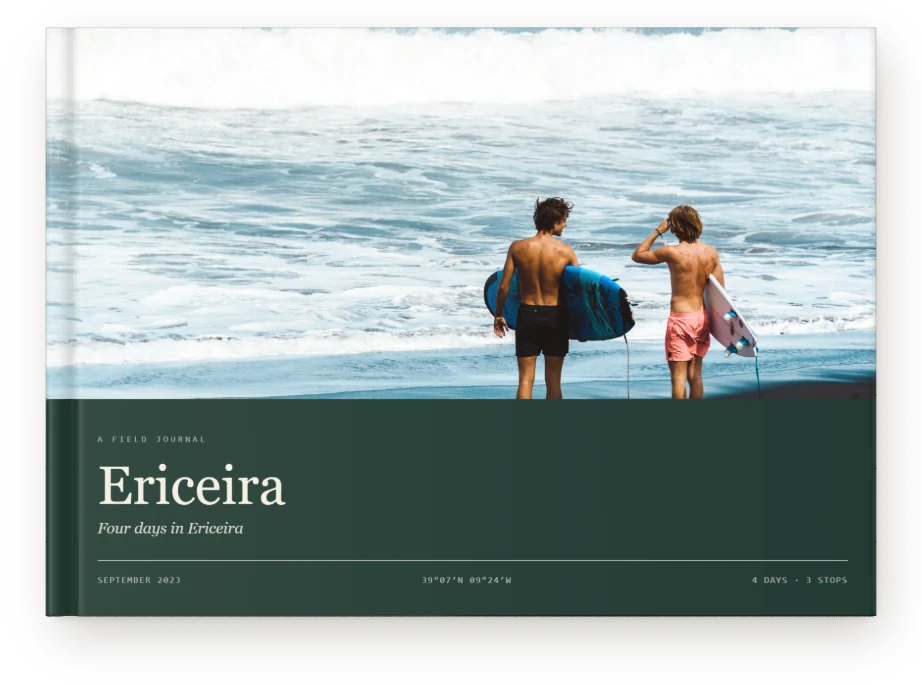 A Travel Book, closed on a table &mdash; two surfers at Ericeira