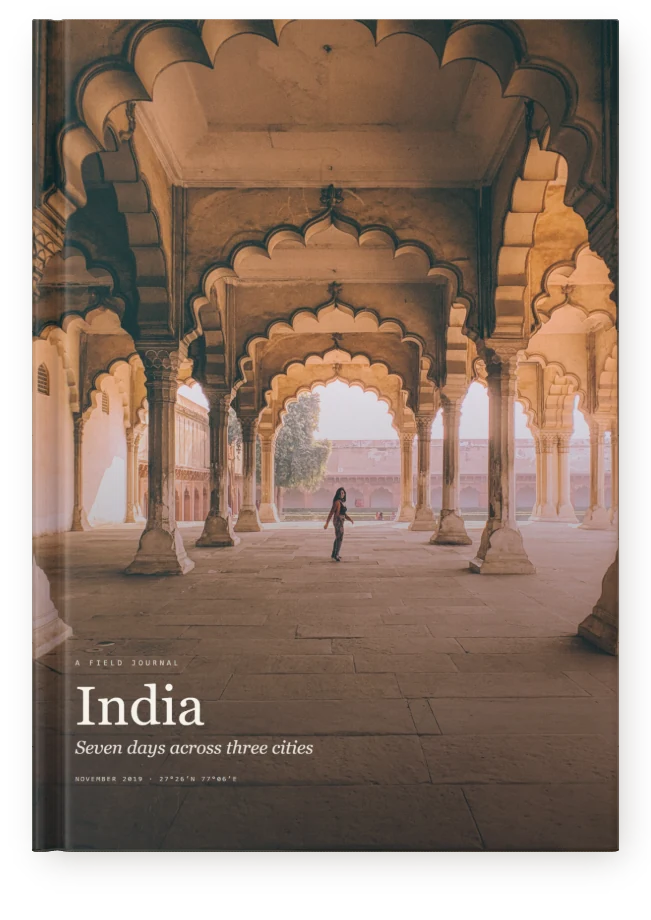 An A4 portrait Travel Book, closed on a table: a tall cover, the title set on the photograph