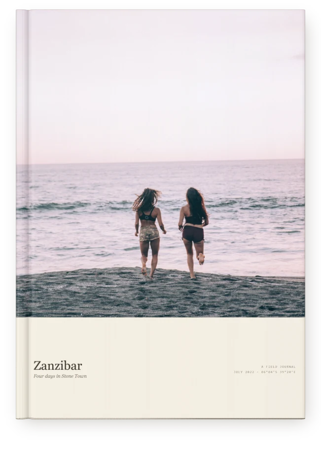 A Travel Book, closed on a table &mdash; a beach at sunset on Zanzibar
