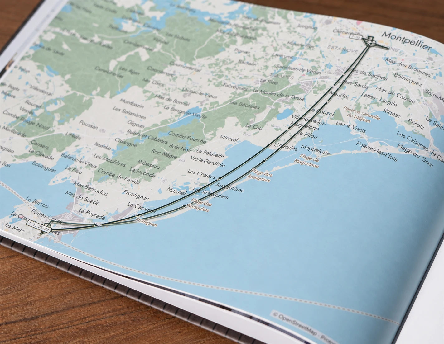 A printed map of the coast from Sète to Montpellier with the trip's routes between them